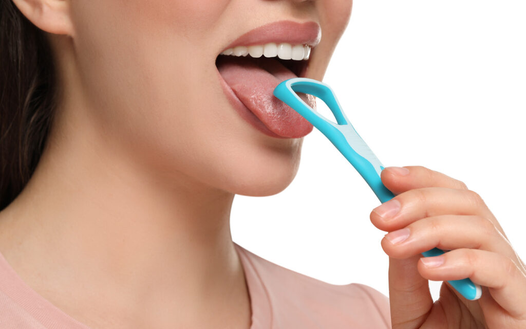 woman cleaning tongue