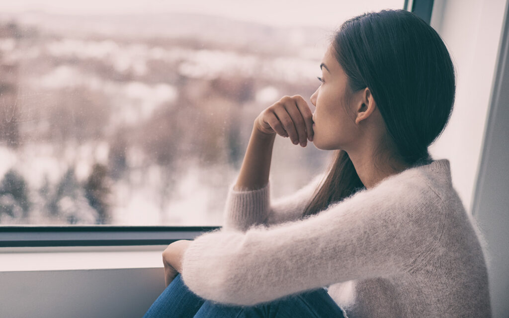 Woman staring out of window